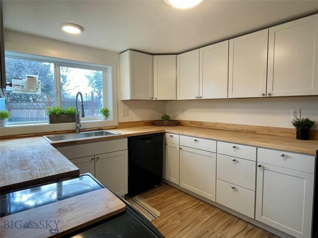 307 W Legion St, Whitehall, MT 59759 - kitchen with butcher block counters, white cabinetry, a sink, and black dishwasher