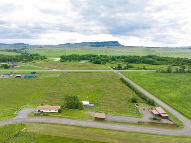 birds eye view of property with a mountain view and a rural view