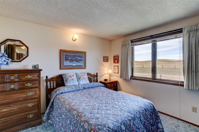 carpeted bedroom with a textured ceiling and baseboards