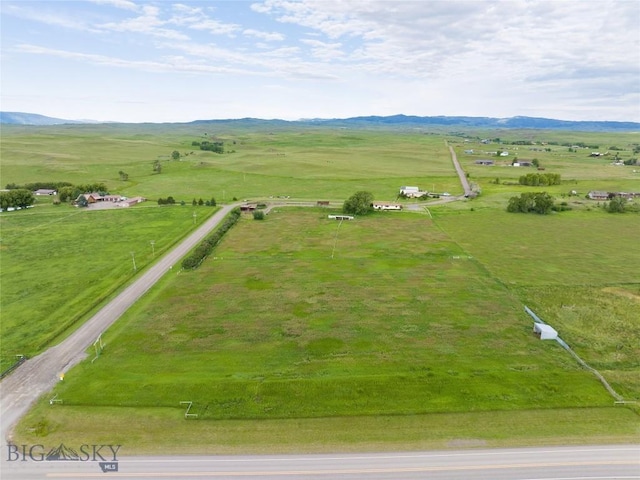 birds eye view of property featuring a mountain view and a rural view