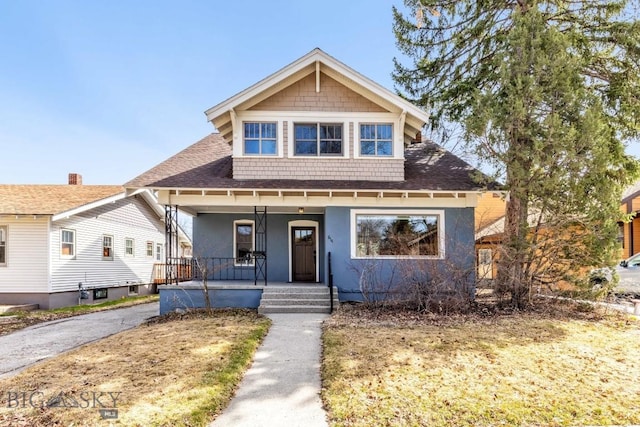 bungalow-style home featuring a porch, stucco siding, and a shingled roof
