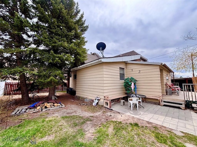 back of property with a patio area, fence, and a deck