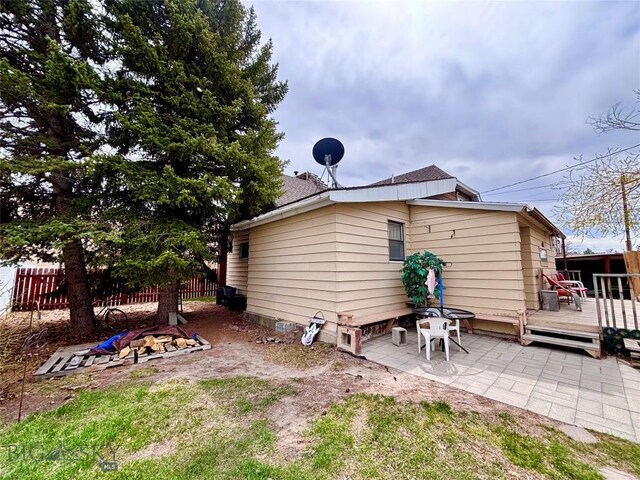 113 N Pacific St, Dillon, MT 59725 - back of property with a deck and a patio area