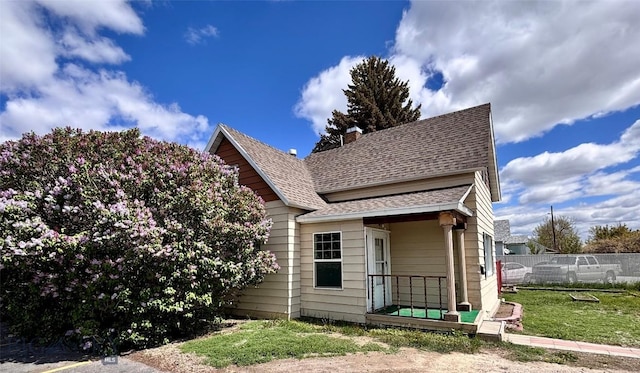 113 N Pacific St, Dillon, MT 59725 - view of front of house with a shingled roof and a chimney