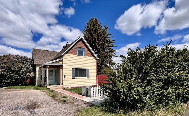 113 N Pacific St, Dillon, MT 59725 - view of front of house with roof with shingles and a chimney