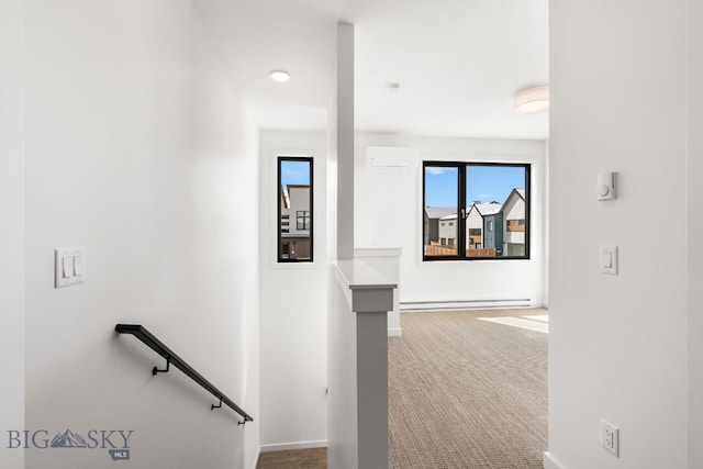 staircase featuring a baseboard heating unit, baseboards, carpet flooring, and a wall mounted AC