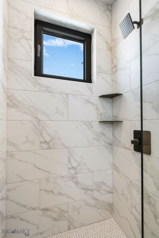 bathroom with a tile shower