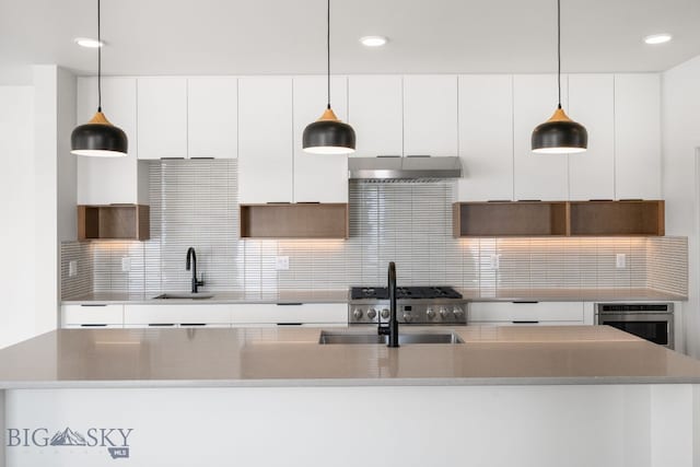 kitchen with white cabinets, oven, and a sink