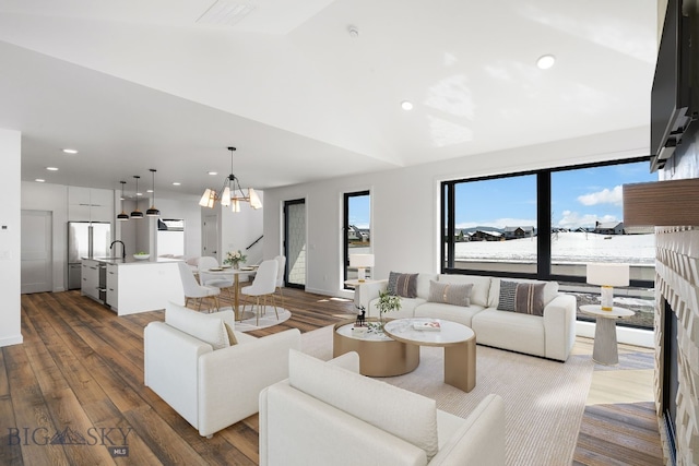 living room with vaulted ceiling, visible vents, dark wood-style floors, and recessed lighting