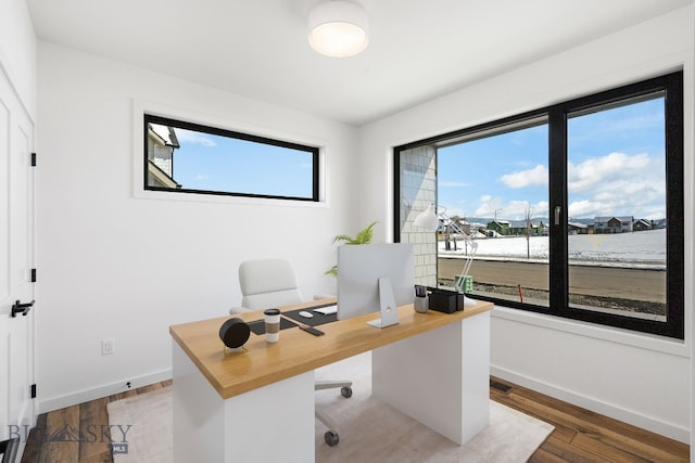 office with visible vents, wood finished floors, and baseboards