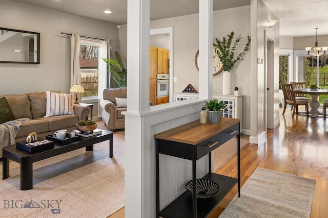 126 Pathfinder Trl, Bozeman, MT 59718 - living area with healthy amount of natural light, light wood-type flooring, a chandelier, recessed lighting, and baseboards