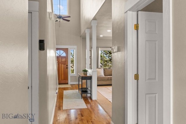 126 Pathfinder Trl, Bozeman, MT 59718 - foyer featuring light wood-style flooring, ceiling fan, baseboards, and decorative columns