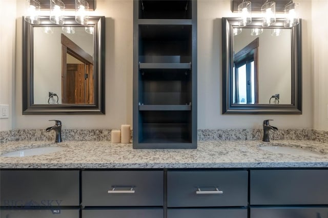 full bathroom featuring a notable chandelier, a sink, and double vanity
