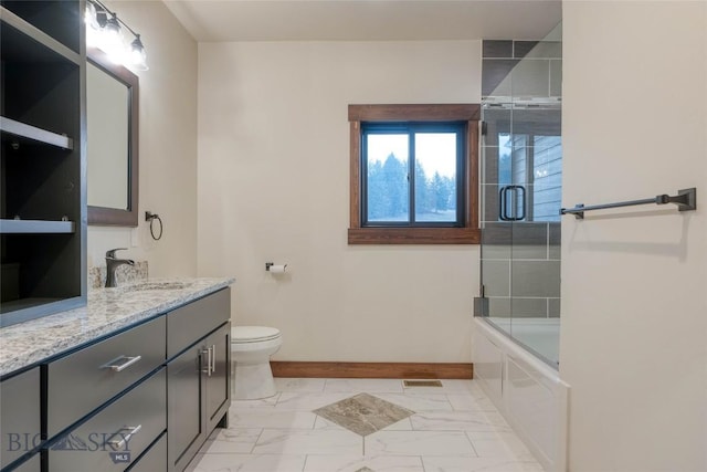 full bathroom featuring marble finish floor, enclosed tub / shower combo, toilet, vanity, and baseboards