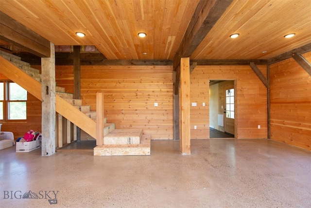 657 Waterloo Rd, Whitehall, MT 59759 - unfurnished living room featuring wooden walls, recessed lighting, wooden ceiling, stairs, and speckled floor