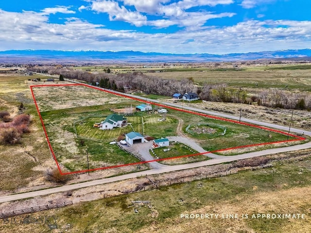 birds eye view of property featuring a mountain view and a rural view