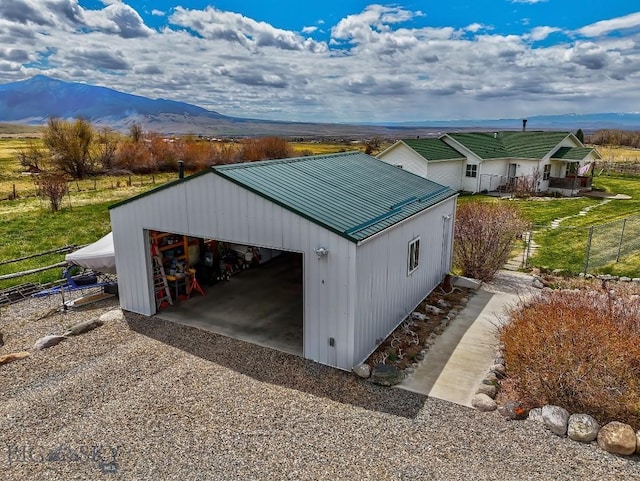 detached garage with fence and a mountain view