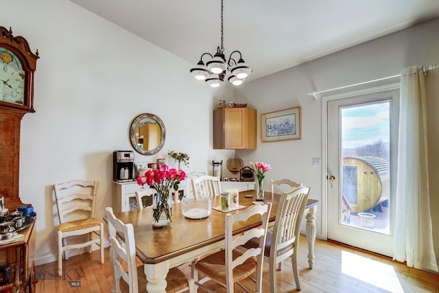 dining room with a chandelier and light wood-style floors