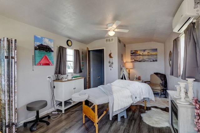 bedroom with wood finished floors, visible vents, a ceiling fan, vaulted ceiling, and a wall mounted AC