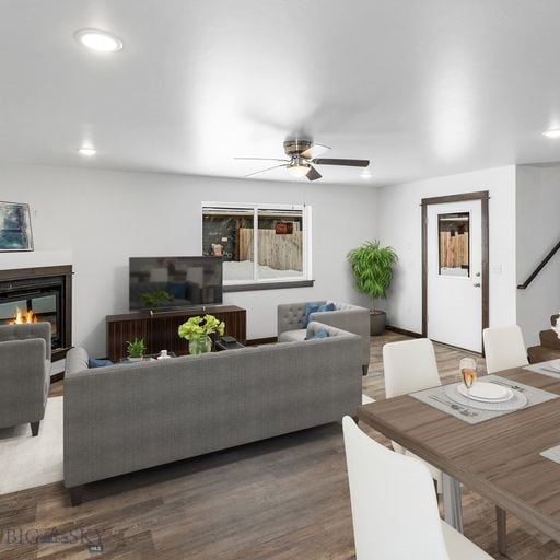 living area featuring ceiling fan, a glass covered fireplace, wood finished floors, and recessed lighting