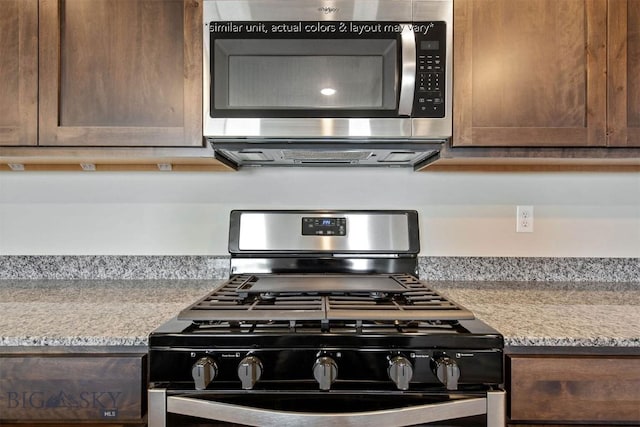 kitchen with stainless steel microwave, light countertops, black gas range, and dark brown cabinetry