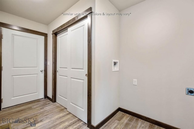washroom featuring laundry area, hookup for an electric dryer, hookup for a washing machine, baseboards, and light wood-style flooring