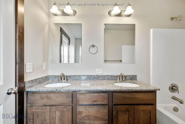 full bathroom with  shower combination, a sink, and double vanity
