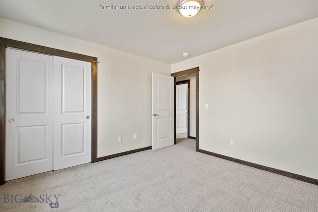 unfurnished bedroom featuring baseboards, a closet, and light colored carpet