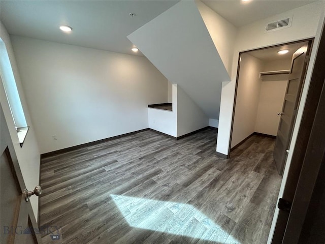 bonus room featuring baseboards, wood finished floors, visible vents, and recessed lighting
