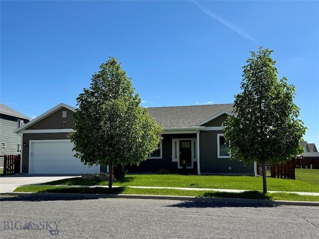1222 Wildflower Trl, Livingston, MT 59047 - obstructed view of property featuring a garage, a front yard, concrete driveway, and a shingled roof