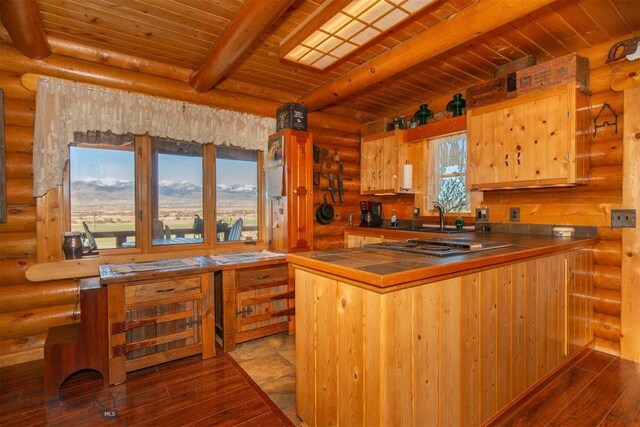 kitchen featuring rustic walls, tile counters, wooden ceiling, dark wood-type flooring, and beamed ceiling