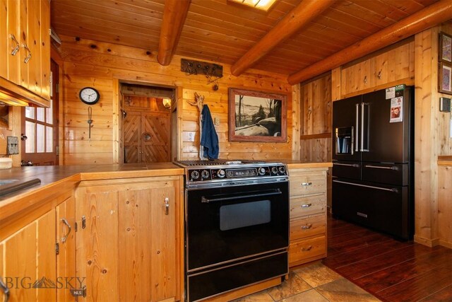 kitchen with tile counters, wood walls, beam ceiling, wood ceiling, and black appliances