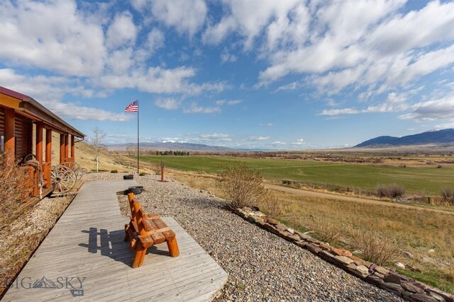 view of yard with a rural view and a mountain view