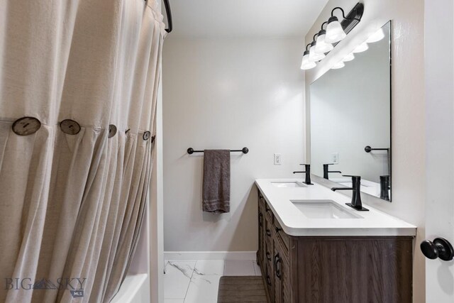 250 Jackson Ln, Belgrade, MT 59714 - full bath with double vanity, baseboards, marble finish flooring, and shower / tub combo