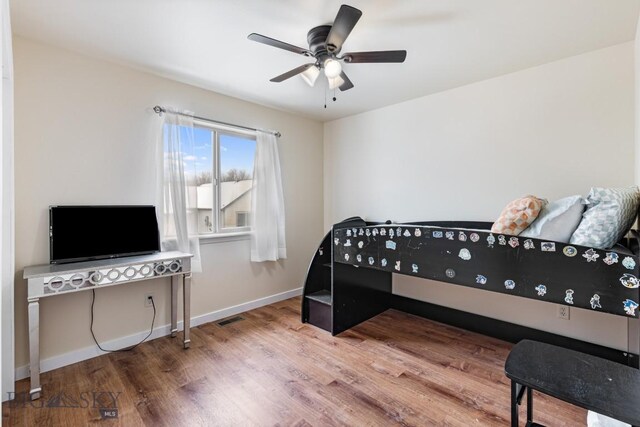 250 Jackson Ln, Belgrade, MT 59714 - bedroom featuring wood finished floors, baseboards, and ceiling fan