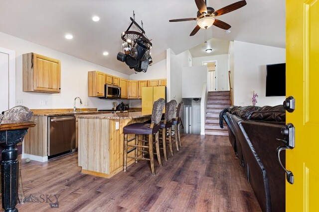 250 Jackson Ln, Belgrade, MT 59714 - kitchen with appliances with stainless steel finishes, lofted ceiling, a breakfast bar, dark wood-style flooring, and ceiling fan