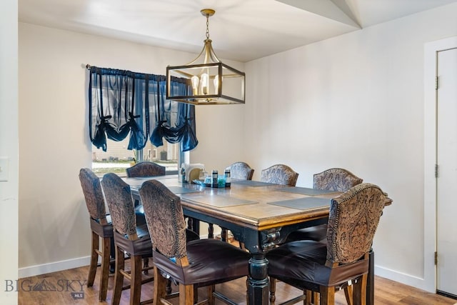 250 Jackson Ln, Belgrade, MT 59714 - dining area featuring a chandelier, baseboards, and wood finished floors