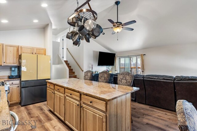 250 Jackson Ln, Belgrade, MT 59714 - kitchen with freestanding refrigerator, vaulted ceiling, ceiling fan, dark wood-style flooring, and a kitchen island