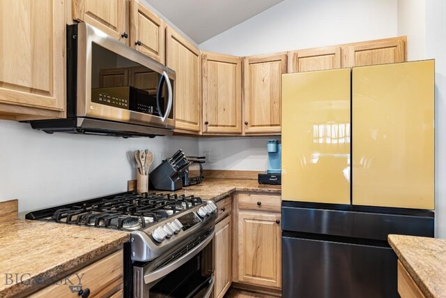 250 Jackson Ln, Belgrade, MT 59714 - kitchen with appliances with stainless steel finishes, light brown cabinets, lofted ceiling, and light countertops