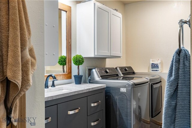 250 Jackson Ln, Belgrade, MT 59714 - washroom featuring separate washer and dryer and cabinet space