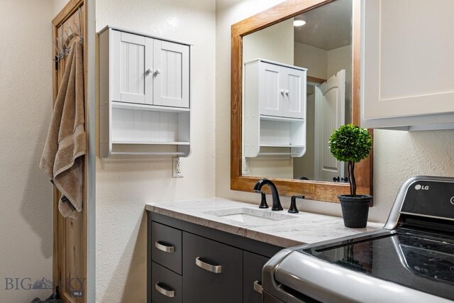 250 Jackson Ln, Belgrade, MT 59714 - bathroom featuring a textured wall and vanity