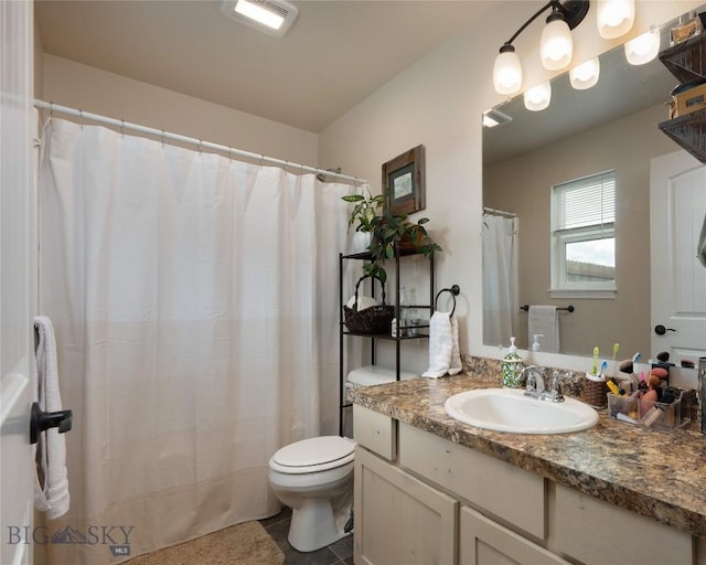 full bathroom featuring tile patterned flooring, toilet, and vanity