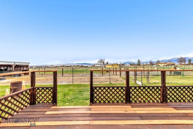 wooden terrace featuring fence and a rural view