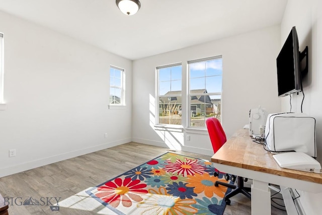 office area featuring baseboards and wood finished floors