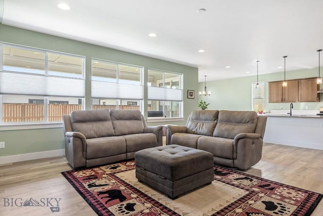 1508 Deadwood Loop, Belgrade, MT 59714 - living room featuring light wood-style floors, recessed lighting, and baseboards