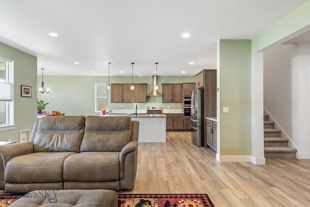 1508 Deadwood Loop, Belgrade, MT 59714 - living room featuring recessed lighting, light wood finished floors, stairs, baseboards, and a chandelier