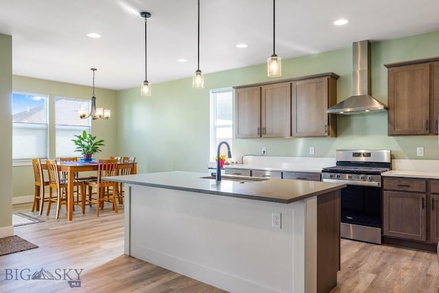 1508 Deadwood Loop, Belgrade, MT 59714 - kitchen featuring stainless steel gas stove, wall chimney exhaust hood, a sink, plenty of natural light, and recessed lighting