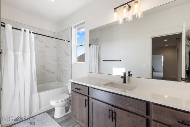 1508 Deadwood Loop, Belgrade, MT 59714 - bathroom with shower / tub combo, toilet, vanity, and wood finished floors