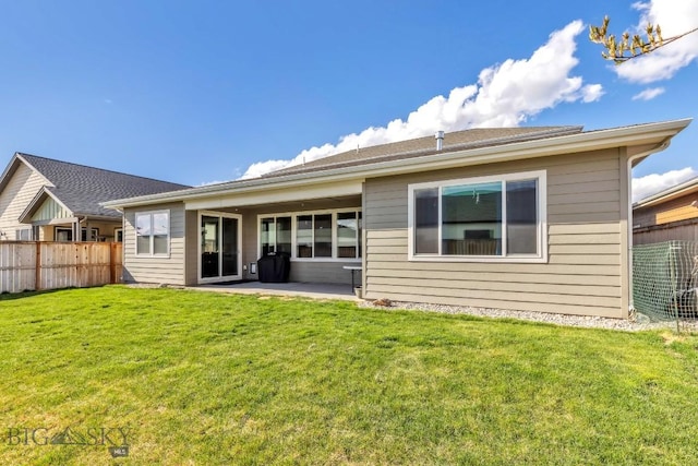 back of house with a yard, fence, and a patio area