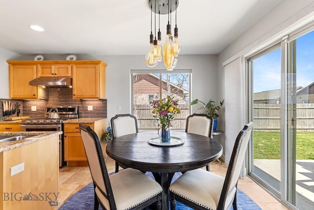 1708 Drummond Blvd, Belgrade, MT 59714 - dining area featuring a chandelier, recessed lighting, and light stone finish flooring